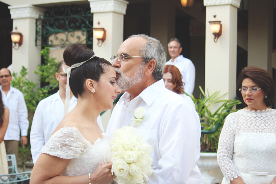 Father kisses the Bride in the forehead
